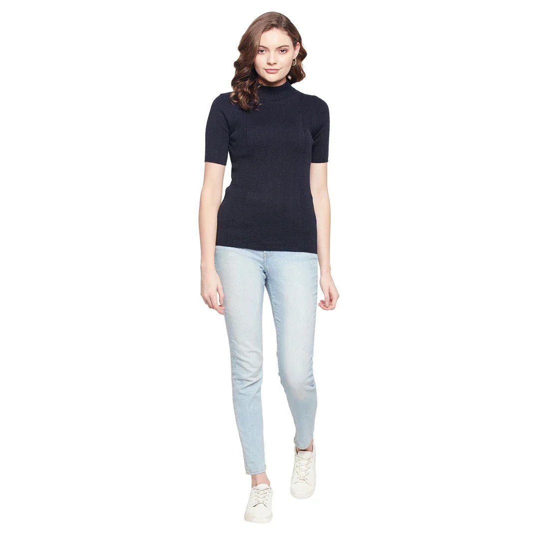Woman in a 98degreenorth navy ribbed half-sleeve slim fit turtle neck sweater stands against a white background.
