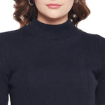 Woman in a 98degreenorth navy blue ribbed slim fit turtle neck sweater, wavy brown hair, silver hoops, cropped at shoulders.
