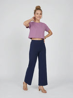 Smiling woman in mauve crop top and 98degreenorth Navy Blue Wide-Leg Cotton Pants—high-rise stretch trousers.