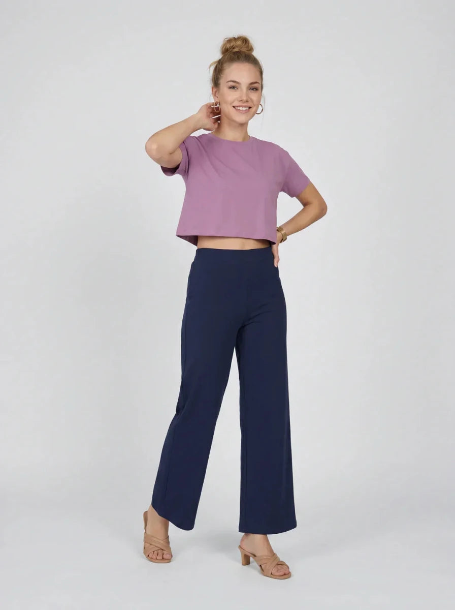 Smiling woman in mauve crop top and 98degreenorth Navy Blue Wide-Leg Cotton Pants—high-rise stretch trousers.