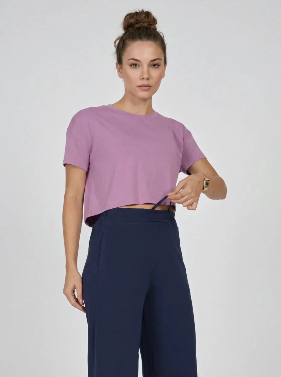 Woman in 98degreenorth Navy Blue Wide-Leg High-Rise Pants stands against a plain background.