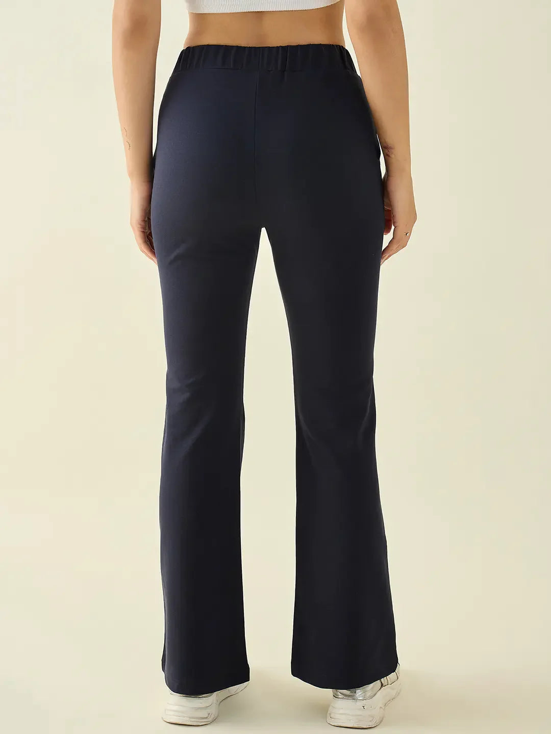 Person in 98degreenorth Women’s Navy Flared Bootcut Cotton Stretchable Trousers, shown from the back against a plain background.