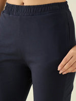 Model wears 98degreenorth Women's Navy Flared Fit Bootcut Cotton Stretchable Trousers, hand on hip, waist to mid-thigh.