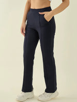 Model wears 98degreenorth Women’s Navy Straight Fit Trousers with white sneakers, posing against a light background.
