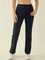 Woman in 98degreenorth Women’s Navy Straight Fit Cotton Stretchable Trousers, one hand in pocket, white sneakers.