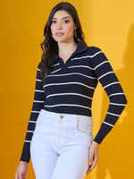 Woman wears 98degreenorth Women’s Navy Striped Collared Knit Sweater with light jeans against a yellow background.