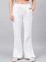 Model wears 98degreenorth Women’s Off-White Bootcut Sweatpants with flared high-waist, styled with white sneakers.