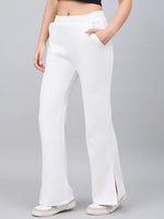 Woman in 98degreenorth Off-White Bootcut Sweatpants, white sneakers, and a black crop top.