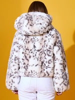 Person wears 98degreenorth Women’s Off-White Faux Fur Jacket, plush winter outerwear, seen from the back on yellow.