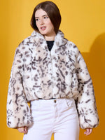 Woman wears 98degreenorth Women’s Off-White Faux Fur Jacket, premium winter outerwear, against a yellow background.