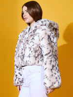 Woman wears 98degreenorth’s Off-White Faux Fur Jacket, premium winter outerwear, against a yellow background.