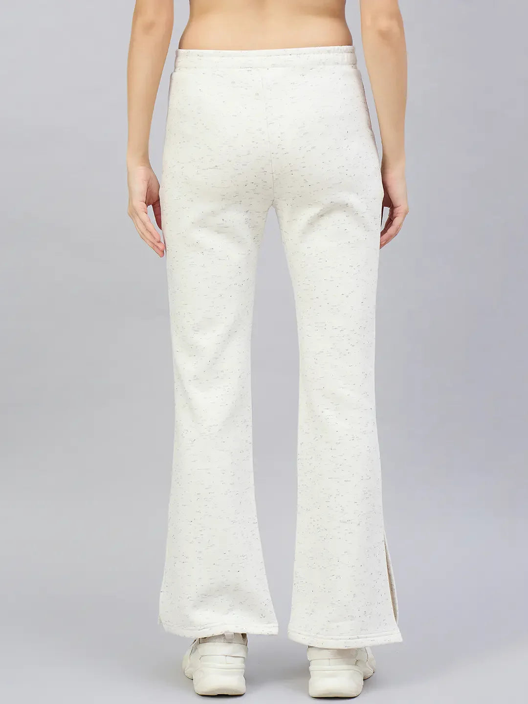 A person wears 98degreenorth Women's Off-White Hairy Texture Bootcut Sweatpants with side slit and white sneakers, back view.