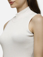 Woman in 98degreenorth’s off-white ribbed high neck sleeveless knit top, classic slim fit tank for daily wear.