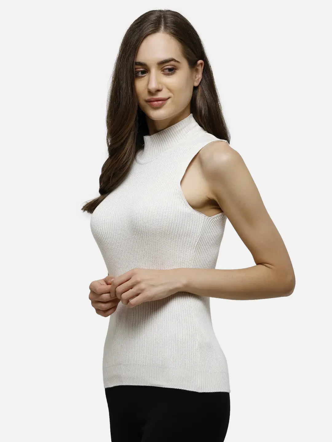 Woman in a 98degreenorth off-white ribbed high neck sleeveless knit top, paired with black pants.