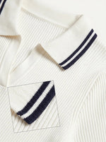 Close-up of 98degreenorth's Women's Off-White Ribbed Knit Polo Top with a navy-tipped collar.