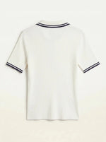 Women's off-white ribbed polo top with navy tipped collar by 98degreenorth, shown from the back.