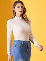 Woman in 98degreenorth Off White Ribbed Turtle Neck Slim Fit Sweater and blue jeans stands against a yellow background.