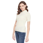 Woman wears 98degreenorth Off White Slim Fit Ribbed Turtle Neck Sweater and blue jeans against a white background.
