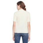 Woman in 98degreenorth off white ribbed turtle neck sweater & blue jeans, shown from the back on white background.