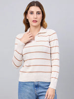 Woman wears 98degreenorth Off-White Striped Collared Sweater with blue jeans, standing against a gray background.
