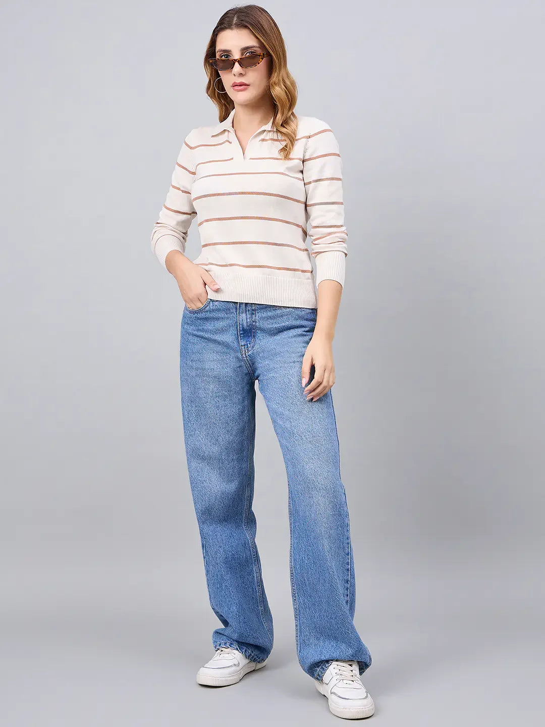 Woman in 98degreenorth Off-White Striped Collared Sweater pairs it with blue jeans, white sneakers, and sunglasses.