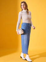 Woman models 98degreenorth’s Off-White Striped Ribbed Turtleneck Sweater with a denim skirt and white boots.