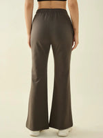 Model wears 98degreenorth Women’s Olive Flared Bootcut Trousers, shown from the back on a light background.