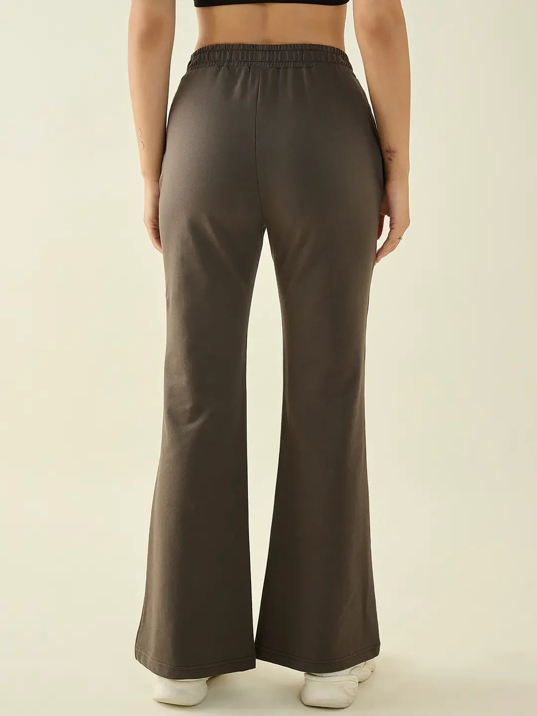 Model wears 98degreenorth Women’s Olive Flared Bootcut Trousers, shown from the back on a light background.