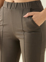 Close-up of a person wearing 98degreenorth Women’s Olive Flared Bootcut Cotton Stretchable Trousers.