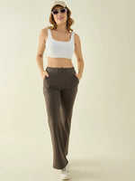 Woman in 98degreenorth Olive Flared Bootcut Cotton Stretchable Trousers stands with hands in her pockets.