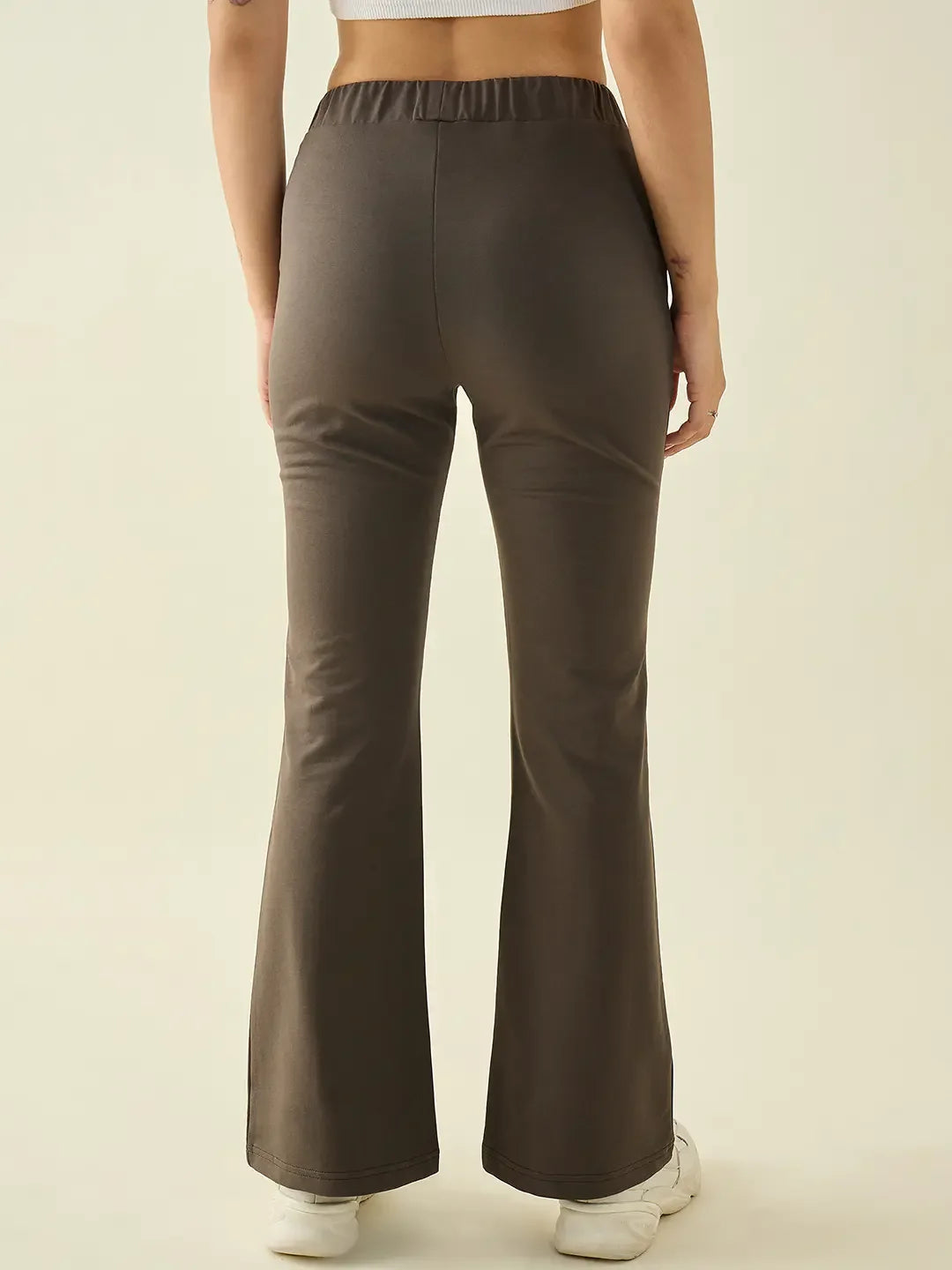 Model in 98degreenorth Women’s Olive Flared Bootcut Cotton Stretchable Trousers, seen from the back against a plain background.