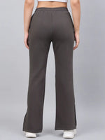 Model wearing 98degreenorth Women’s Olive Green Bootcut Sweatpants with white sneakers, shown from the back.