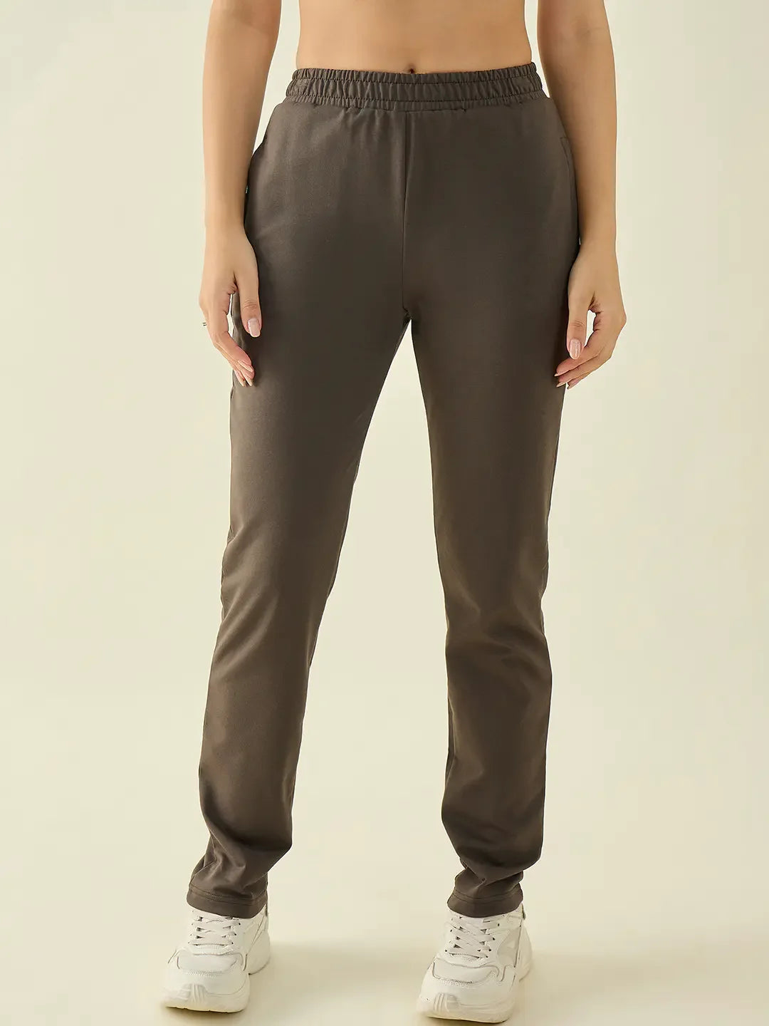 Wearing 98degreenorth Women’s Olive Regular Fit Stretchable Trousers and white sneakers against a light background.