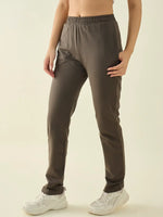 Wearing 98degreenorth Women’s Olive Regular Fit Cotton Stretchable Trousers and white sneakers, against a plain background.