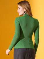 A woman in 98degreenorth’s parrot green high-neck ribbed sweater stands against a yellow background, facing away.
