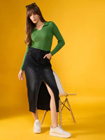 Woman wears 98degreenorth Parrot Green Ribbed Collar Sweater with a dark denim front-slit skirt before a yellow background.