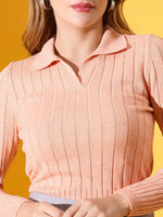 Woman in a 98degreenorth Women’s Peach Melange Ribbed Collar Neck Sweater, standing against a yellow background.