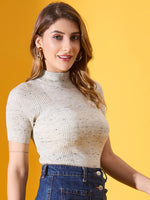 Woman in a 98degreenorth pista green ribbed turtle neck half sleeve sweater, standing against a yellow background.