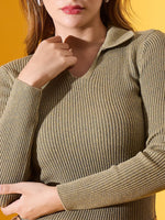 A woman in a 98degreenorth Women’s Pista Melange ribbed collar stretchable sweater against a yellow background.