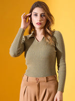A woman in a 98degreenorth Women’s Pista Melange Ribbed Collar Sweater poses in tan pants before a yellow background.