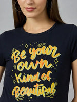 Woman in a 98degreenorth pure cotton typography t-shirt—street-ready style in black with yellow-orange text.