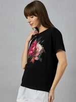 Woman in 98degreenorth Women’s Regular Fit Typography Print Cotton T-shirt and white shorts, standing sideways.