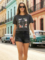 Woman in 98degreenorth’s Relaxed Fit Typography Printed Cotton Tee – Street Style walks past vintage cars.