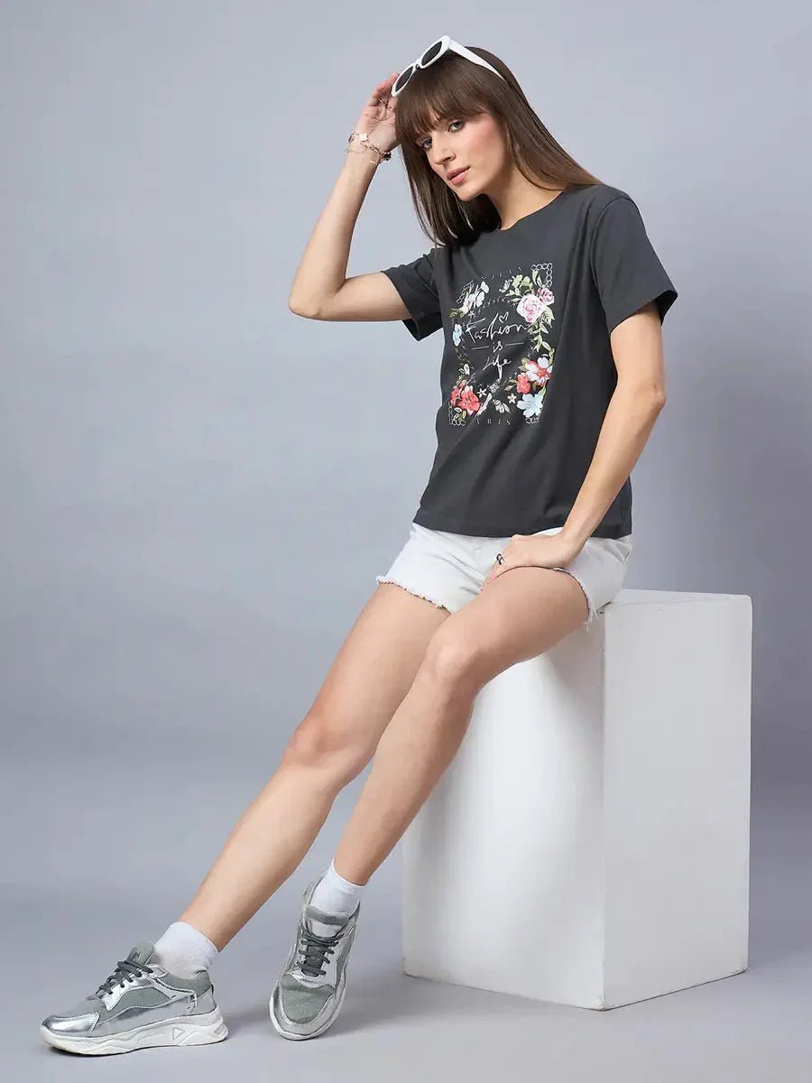 Woman wears 98degreenorth Women’s Relaxed Fit Typography Printed Cotton Tee with white shorts and silver sneakers.