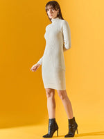 Woman wears a 98degreenorth off-white ribbed bodycon turtleneck dress, paired with black ankle boots on yellow backdrop.