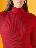 Woman wears 98degreenorth Women’s Ribbed Knitted Bodycon Dress – Red turtleneck, with hoop earrings, on yellow background.