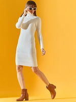 Woman wears 98degreenorth Women’s Ribbed Knitted Bodycon Dress in white, posing stylishly against a yellow background.