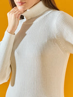 Woman in a white 98degreenorth ribbed knit turtleneck dress, shoulders up, against a bright yellow background.