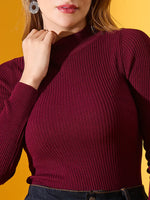 98degreenorth Women’s Rosewood Ribbed High-Neck Sweater, slim fit, styled with dark jeans against a yellow backdrop.