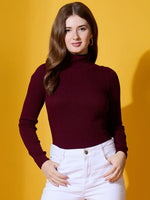 Woman in a 98degreenorth Rosewood Ribbed Turtle-Neck Pullover poses against a bright yellow background, smiling slightly.
